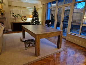 7' Santa Fe Walnut Rosetta dining table with a modern wood finish, displayed in a cozy living room.